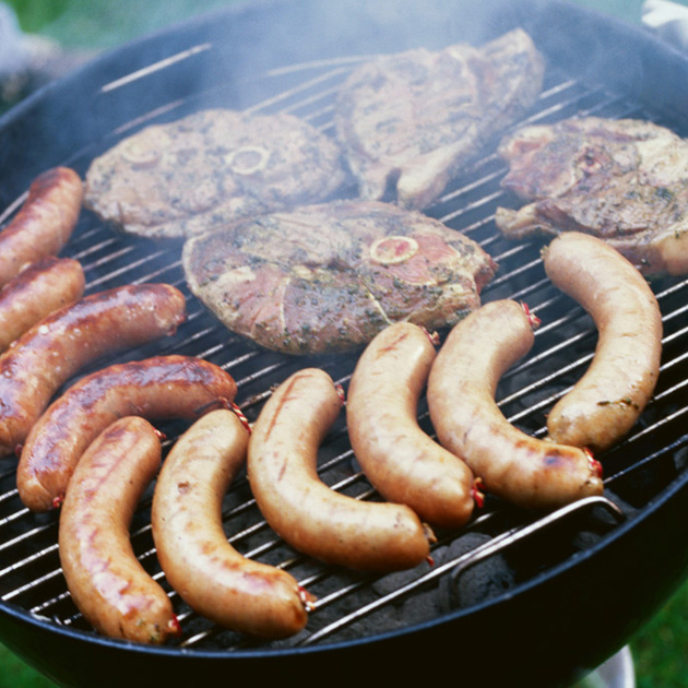 Assorted meats being grilled image