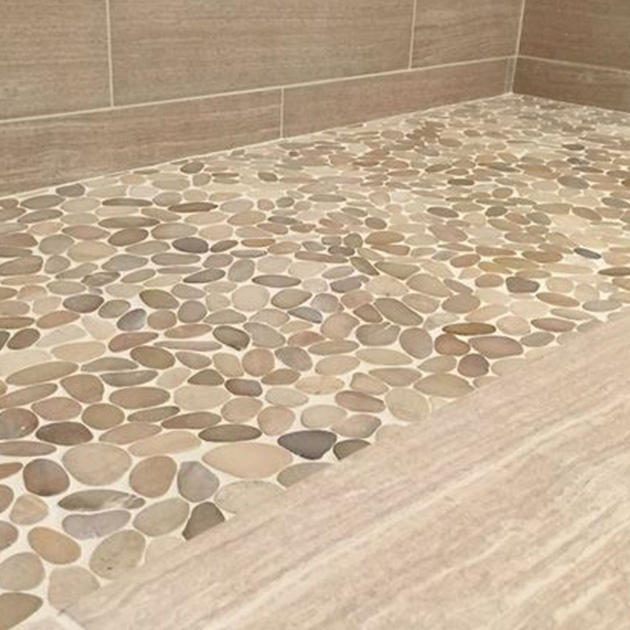 Photo of rock flooring and tile wall