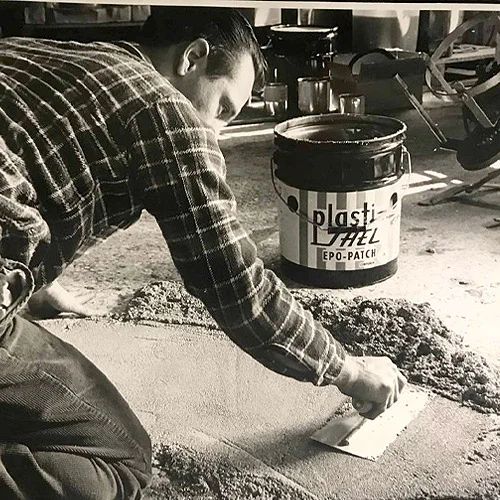 Photo of man smoothing epoxy on floor