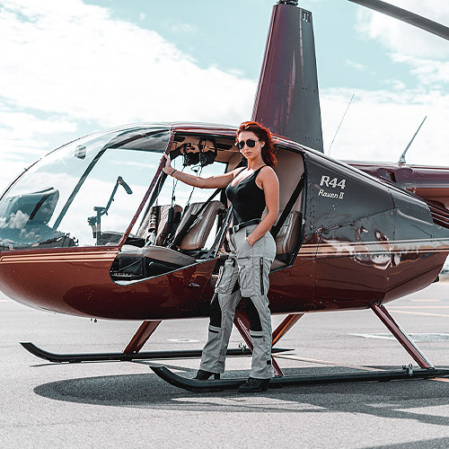 Photo of a woman standing by a helicopter