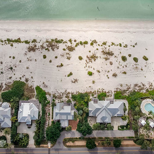 Aerial view of homes beside beach