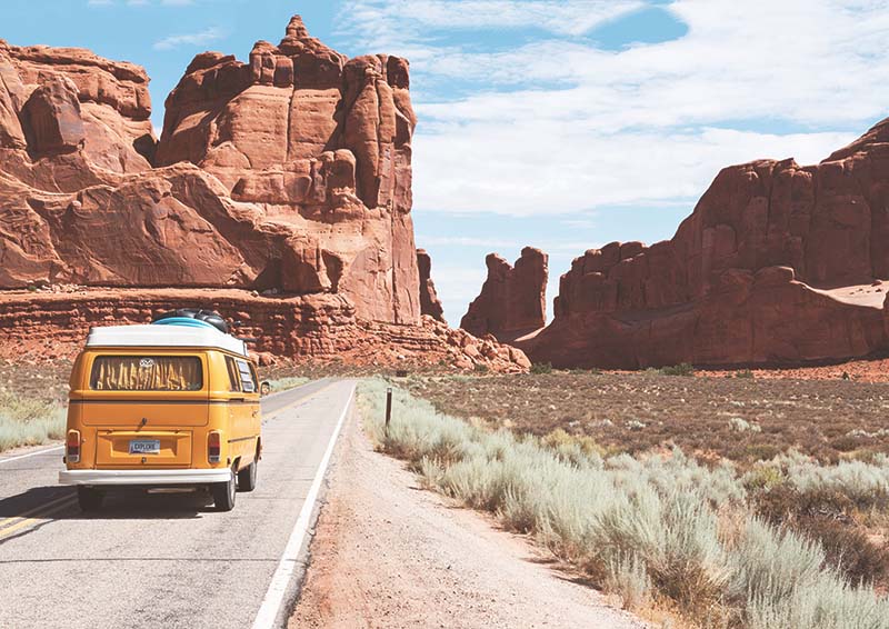Yellow van driving through desert